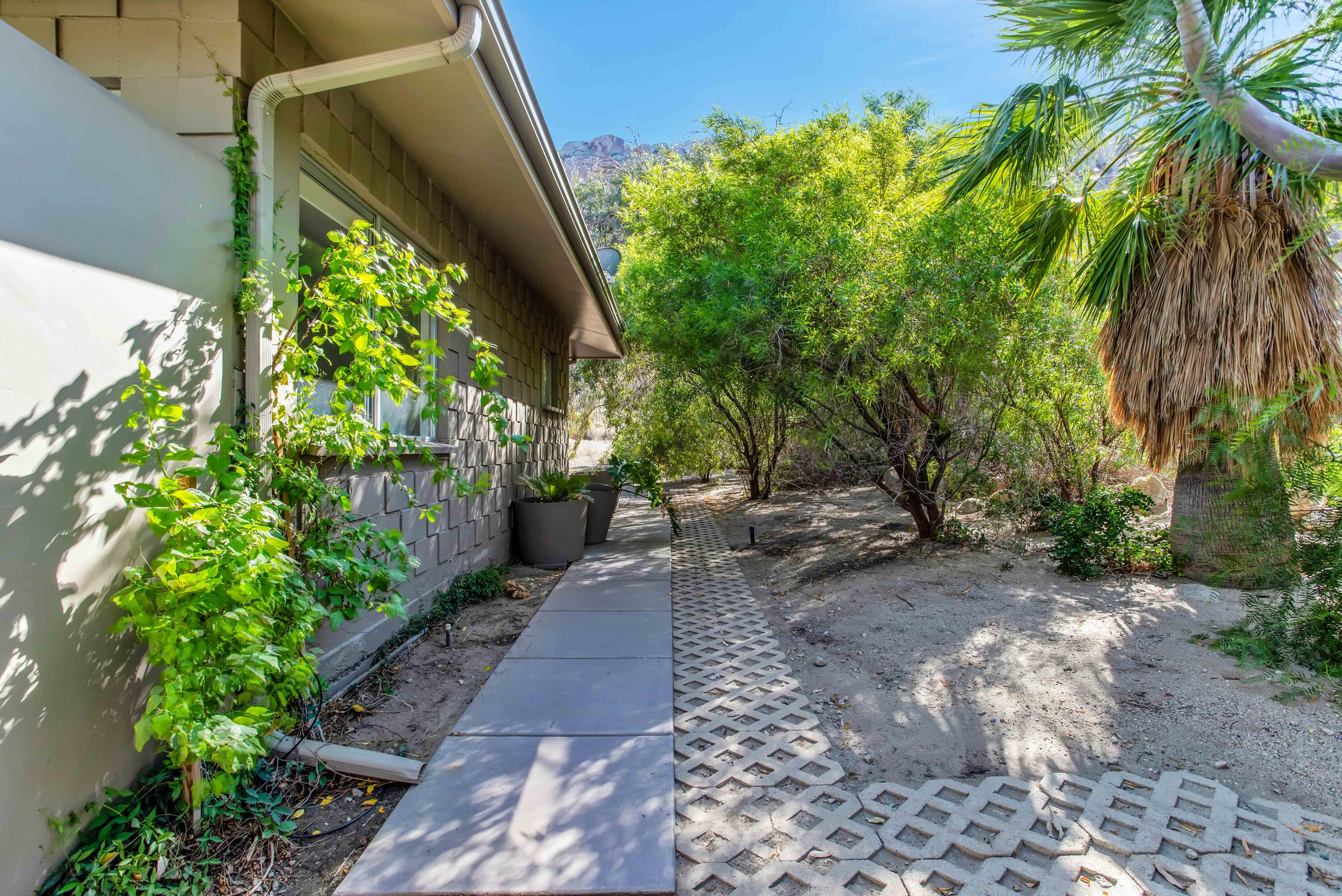 15971 Snowcreek Canyon Road Whitewater, CA 92282 - Photo 23 of 45 a backyard of a house with lots of green space