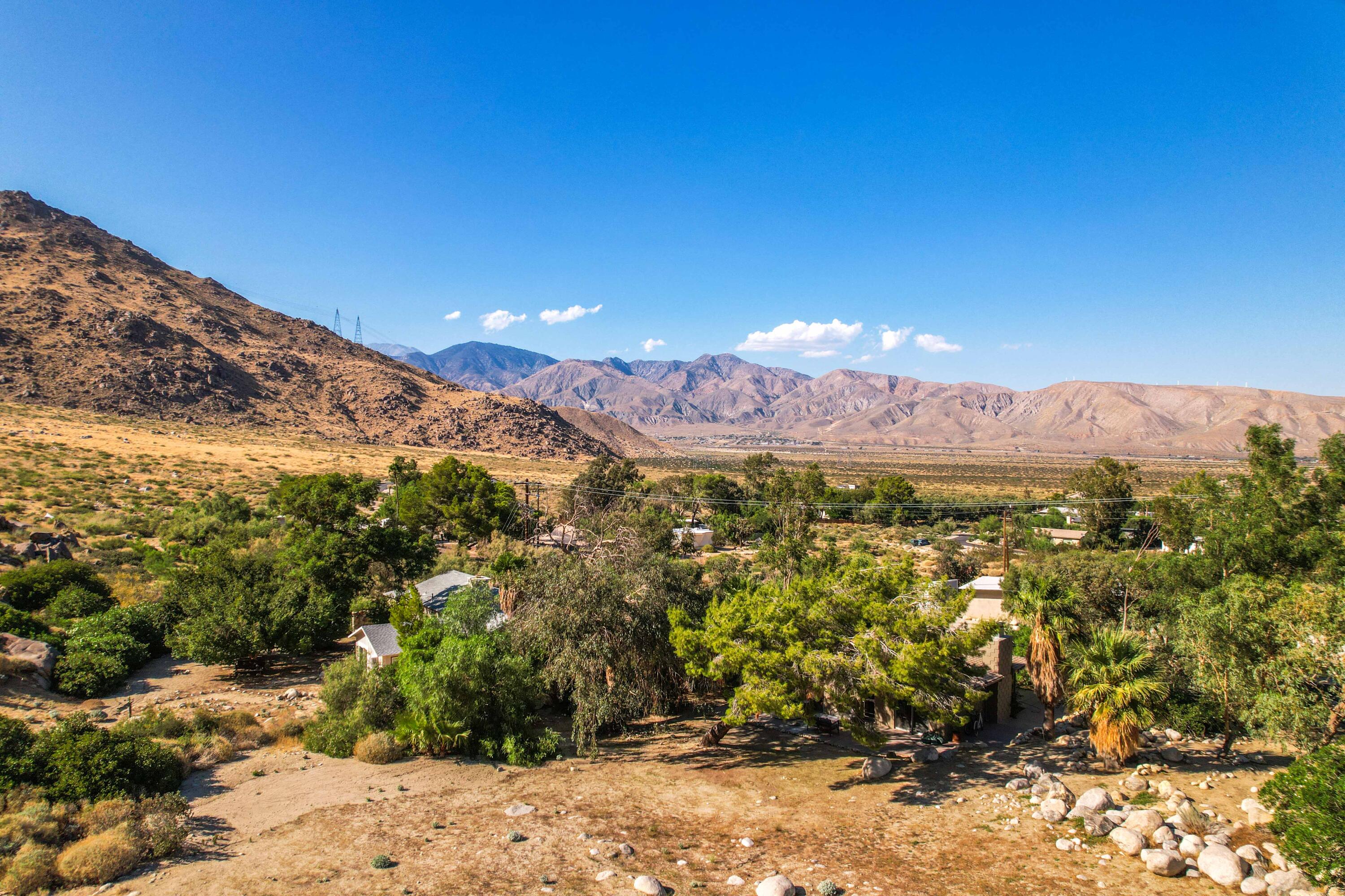 15971 Snowcreek Canyon Road Whitewater, CA 92282 - Photo 33 of 45 a view of a lush green field with mountains in the background