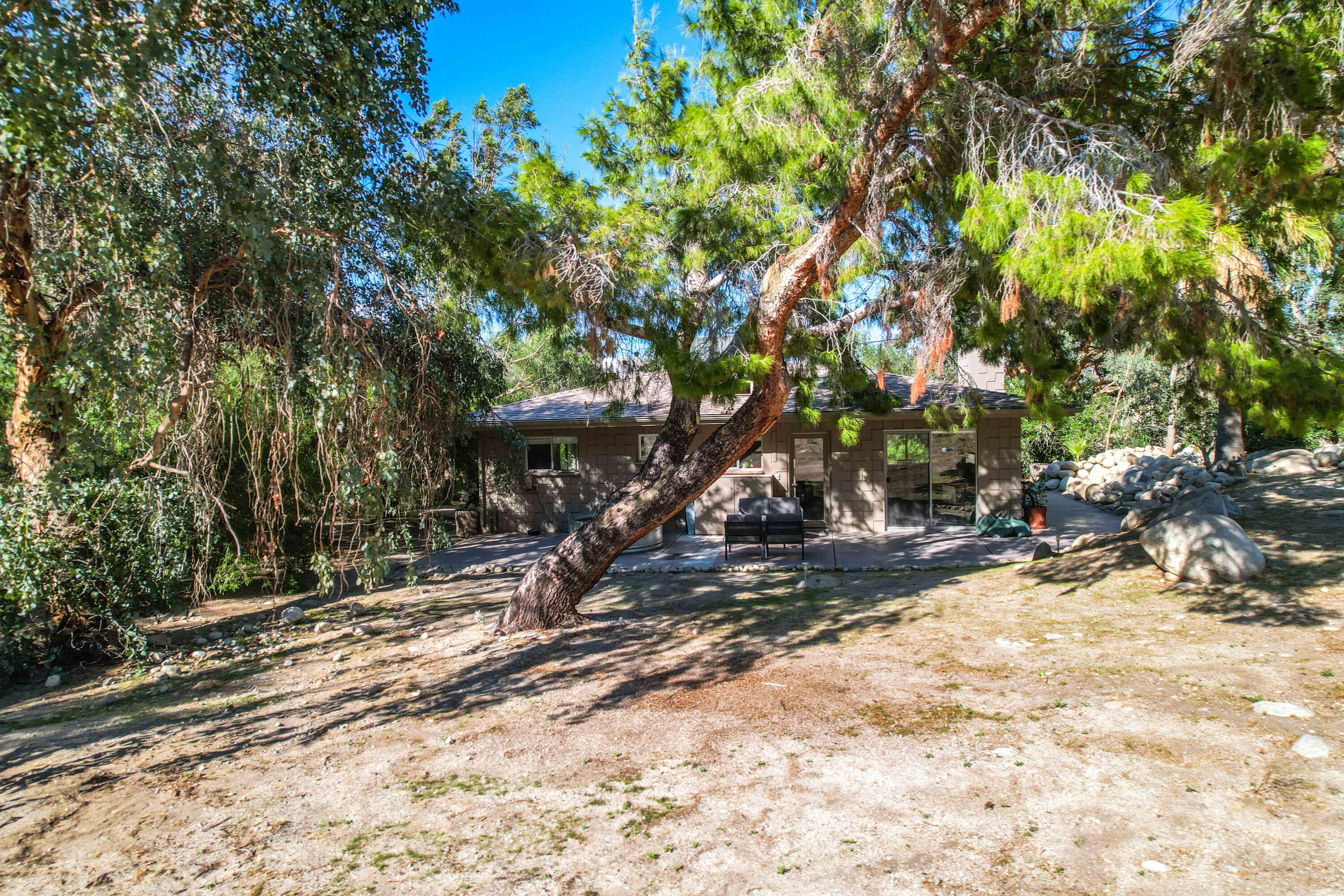 15971 Snowcreek Canyon Road Whitewater, CA 92282 - Photo 36 of 45 a view of a wooden house with a tree