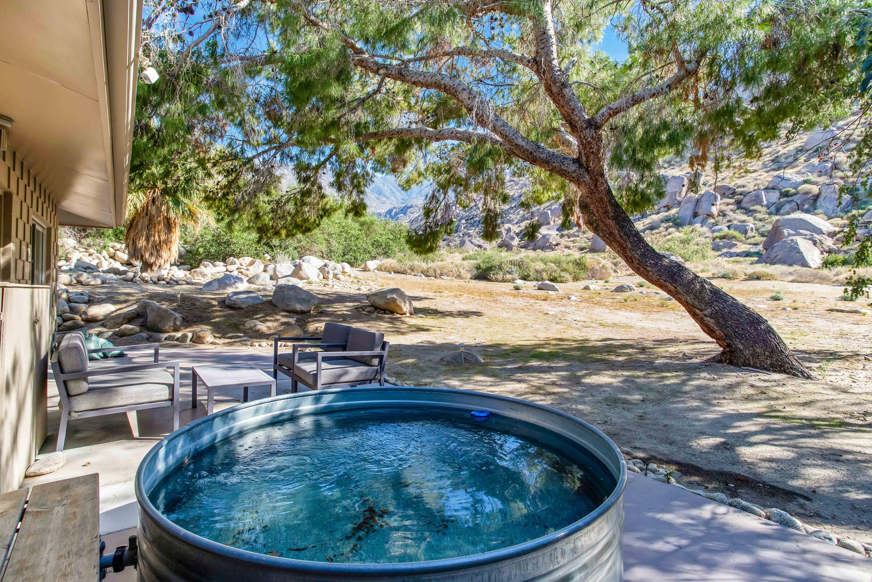 15971 Snowcreek Canyon Road Whitewater, CA 92282 - Photo 38 of 45 a view of a swimming pool with sitting area