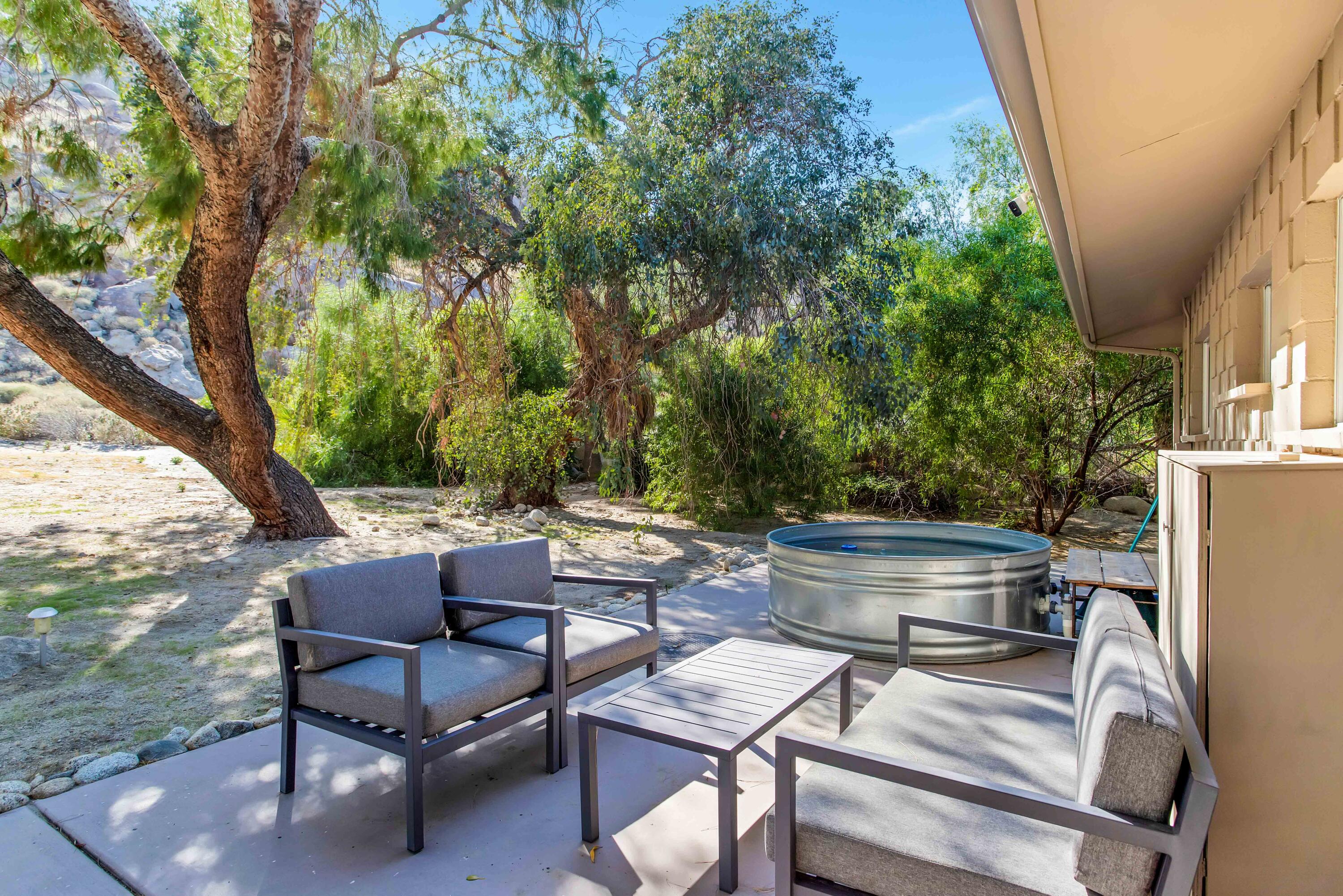 15971 Snowcreek Canyon Road Whitewater, CA 92282 - Photo 39 of 45 a view of patio with chairs and a table