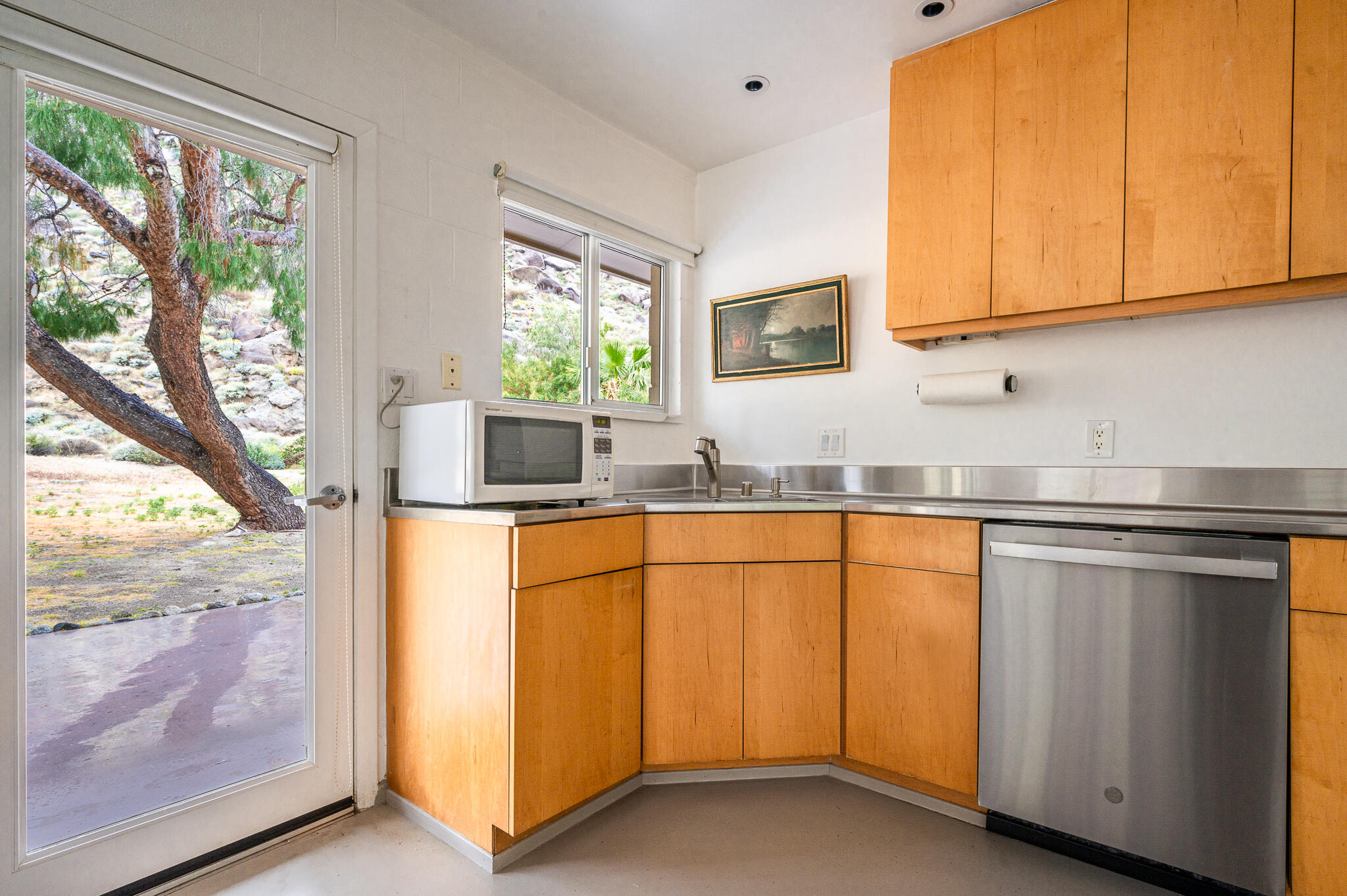 15971 Snowcreek Canyon Road Whitewater, CA 92282 - Photo 8 of 45 a kitchen with stainless steel appliances granite countertop white cabinets a window and a sink