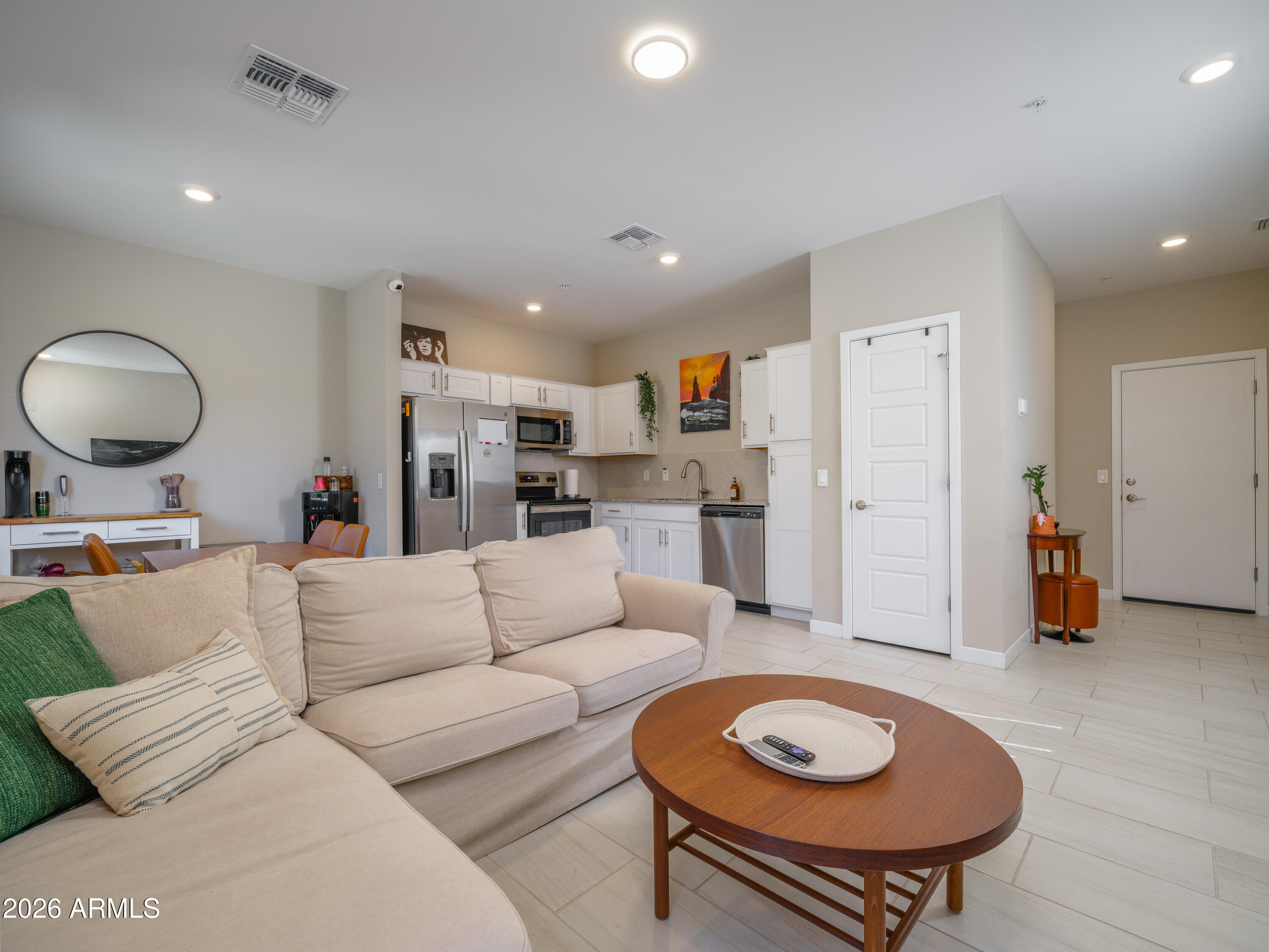 2170 West Harmont Drive Phoenix, AZ 85021 - Photo 1 of 32 a living room with furniture and a dining table with kitchen view