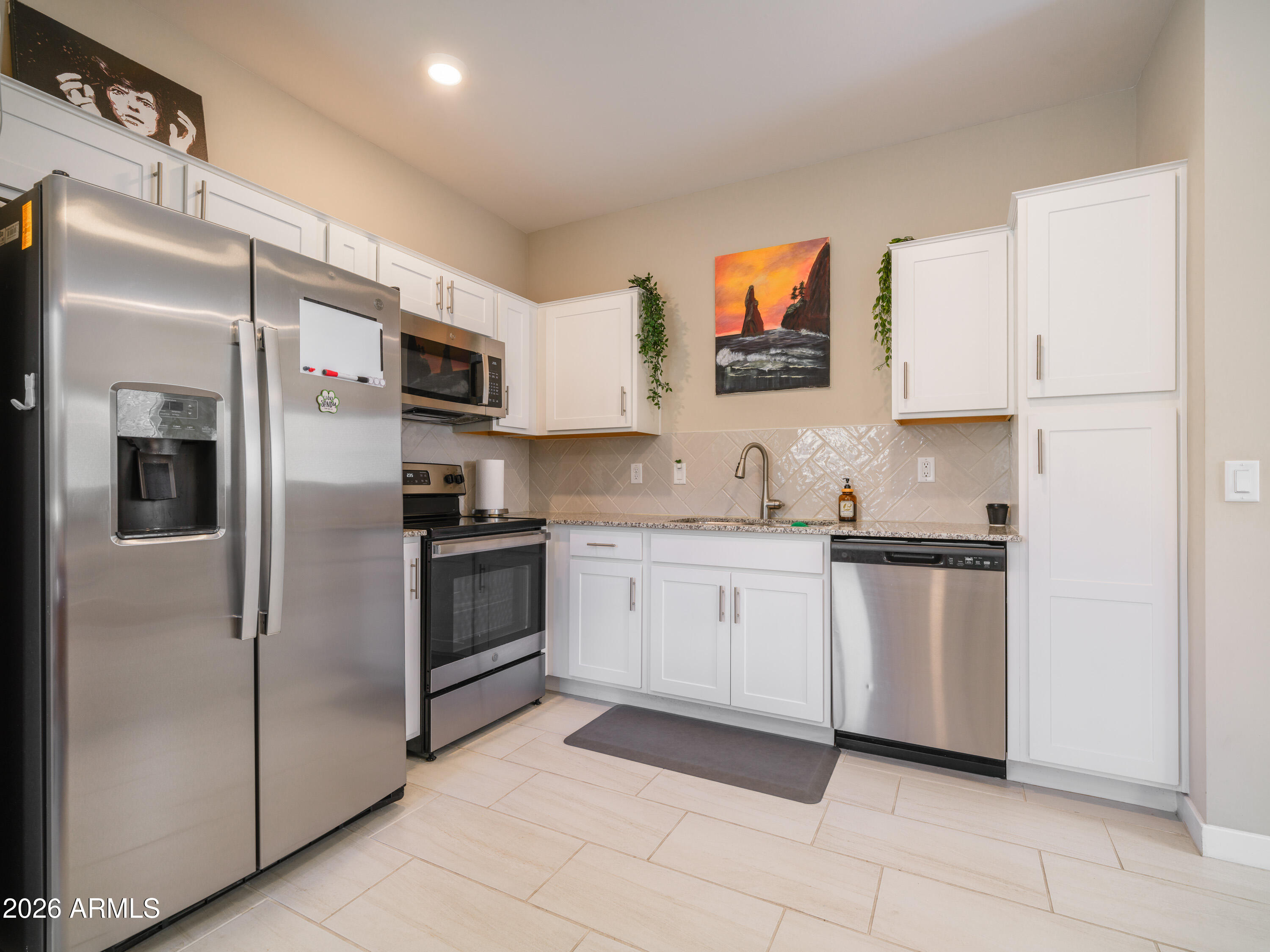 2170 West Harmont Drive Phoenix, AZ 85021 - Photo 5 of 32 a kitchen with stainless steel appliances granite countertop a refrigerator and a stove