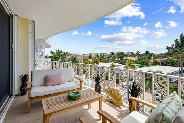 a roof deck with couches and wooden floor