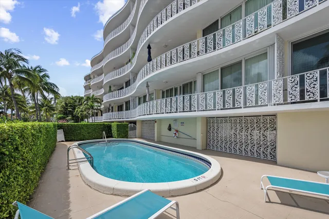 a view of a swimming pool with an outdoor seating area