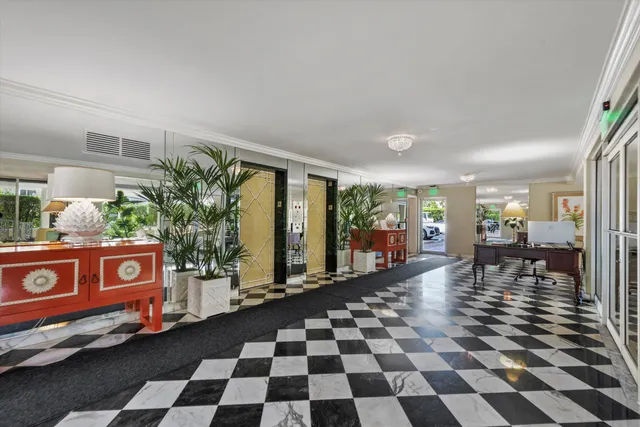 a black and white checkered floor with a large mirror next to a window