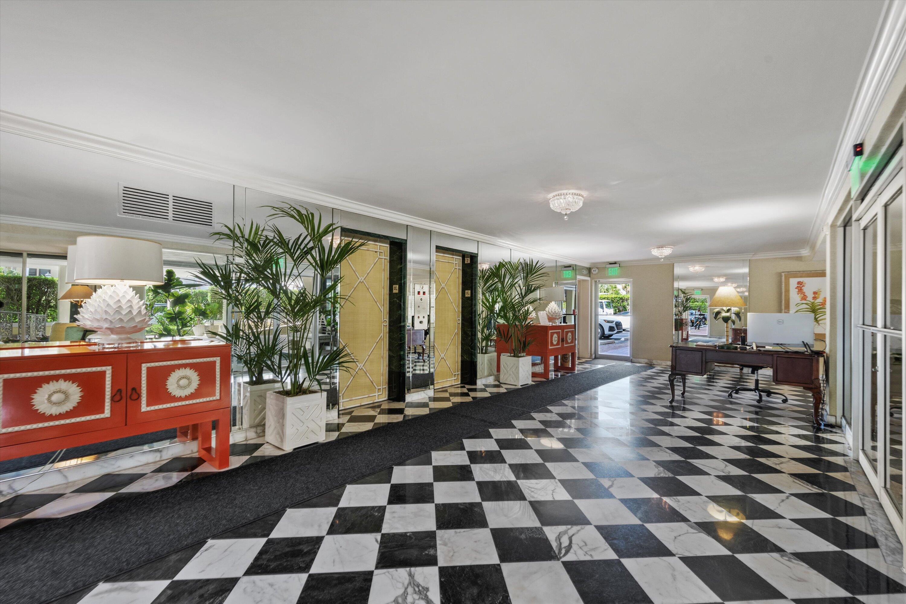 227 Australian Avenue, Unit 4C Palm Beach, FL 33480 - Photo 15 of 16 a black and white checkered floor with a large mirror next to a window