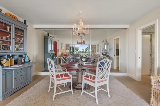 a view of a dining room with furniture and chandelier