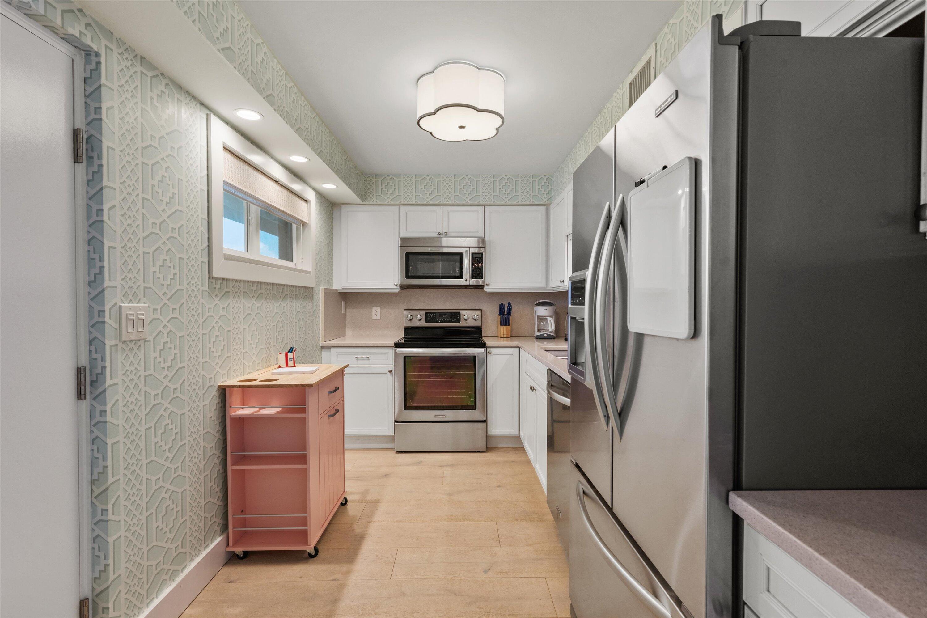 227 Australian Avenue, Unit 4C Palm Beach, FL 33480 - Photo 5 of 16 a kitchen with granite countertop a refrigerator and a stove top oven