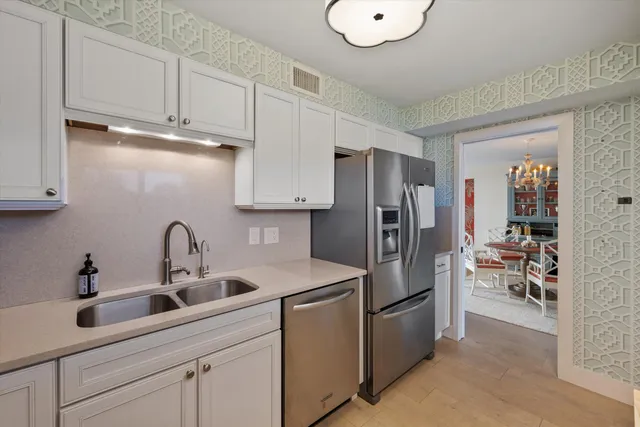 a kitchen with stainless steel appliances a refrigerator sink and cabinets