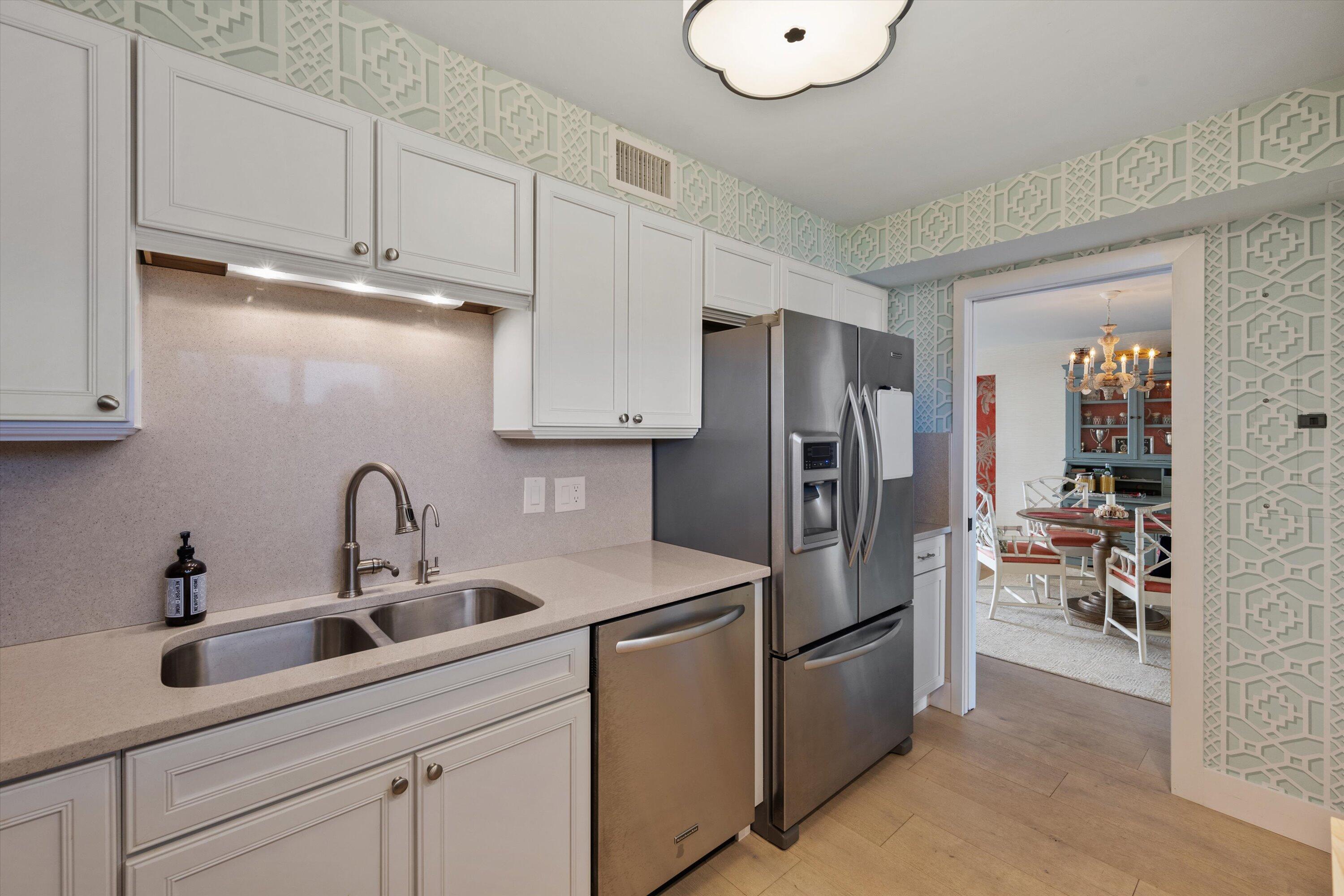 227 Australian Avenue, Unit 4C Palm Beach, FL 33480 - Photo 6 of 16 a kitchen with stainless steel appliances a refrigerator sink and cabinets