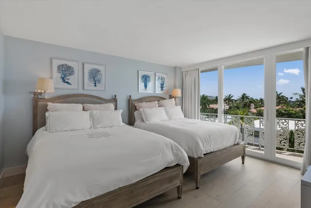 a bedroom with a large bed and a large window