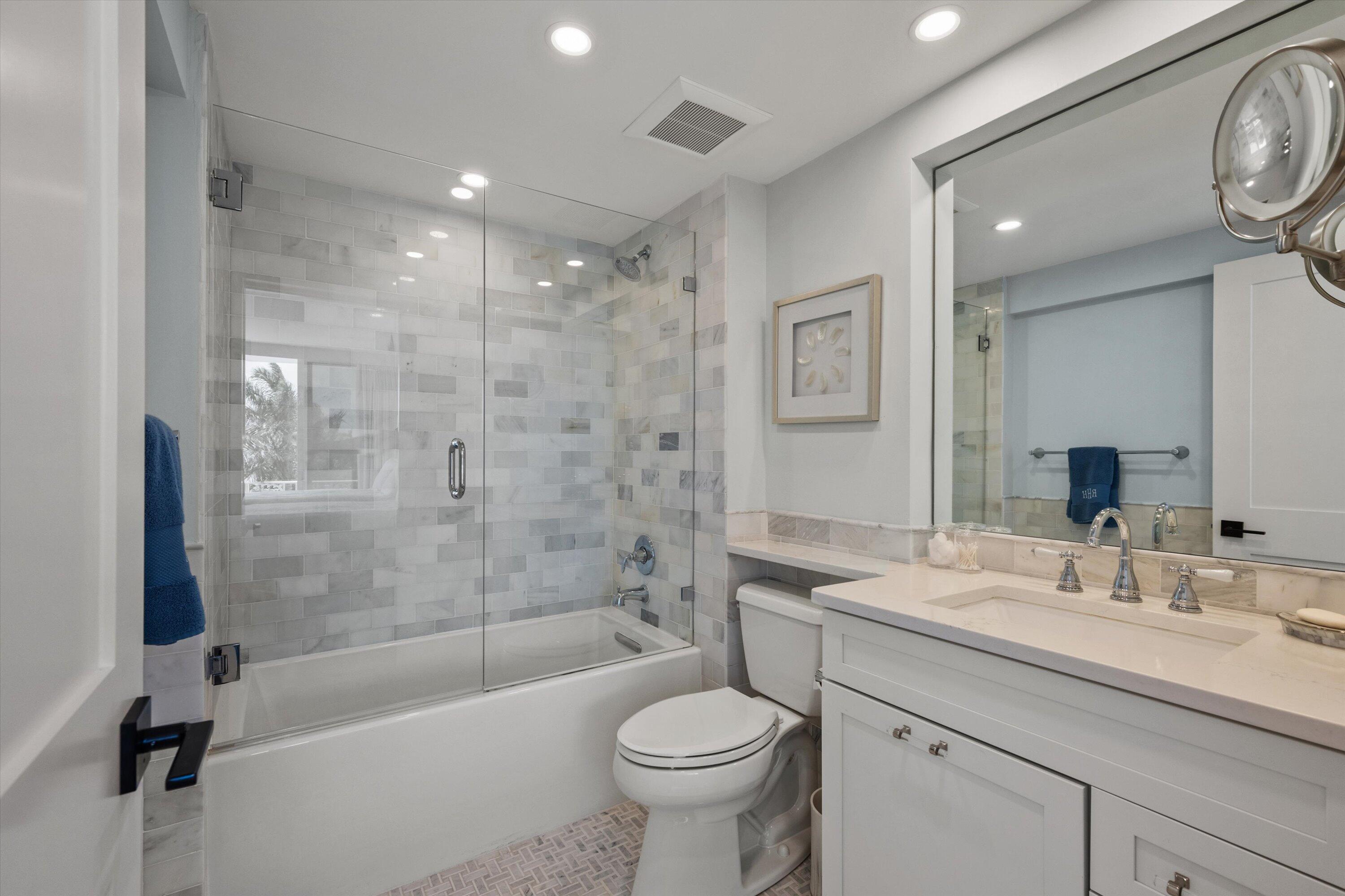 227 Australian Avenue, Unit 4C Palm Beach, FL 33480 - Photo 8 of 16 a bathroom with a sink a toilet and a bathtub