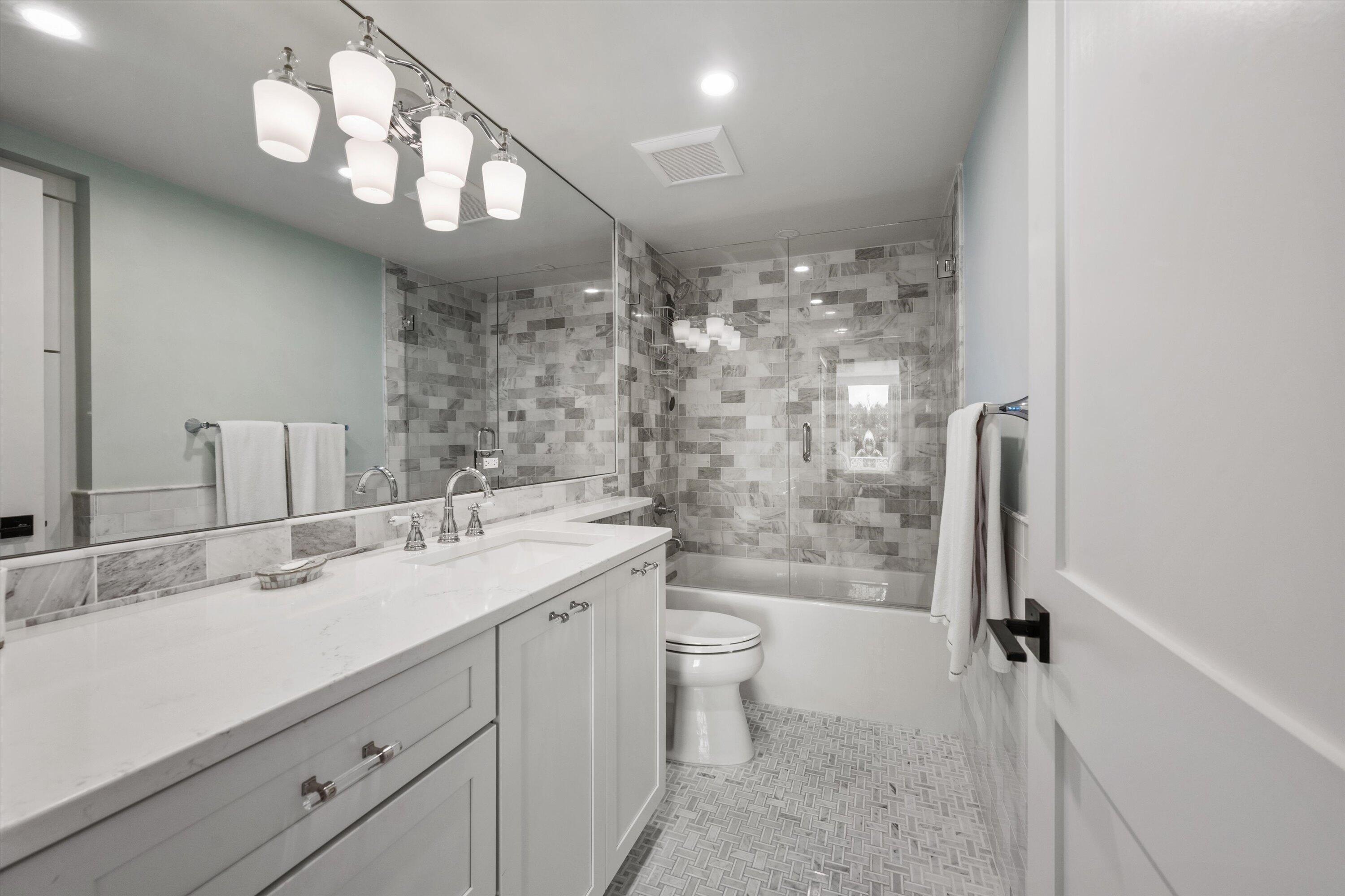 227 Australian Avenue, Unit 4C Palm Beach, FL 33480 - Photo 10 of 16 a bathroom with a sink a toilet a mirror and shower