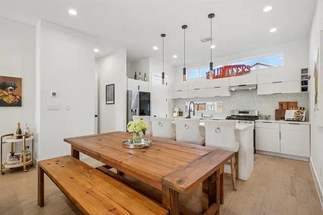 a kitchen with kitchen island stainless steel appliances and wooden floor