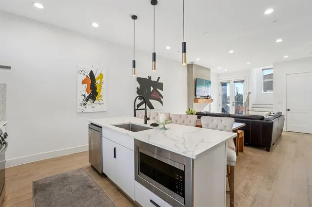 a kitchen with a sink a counter space appliances and cabinets