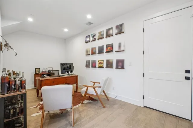a living room with furniture a dining table and a stove top oven