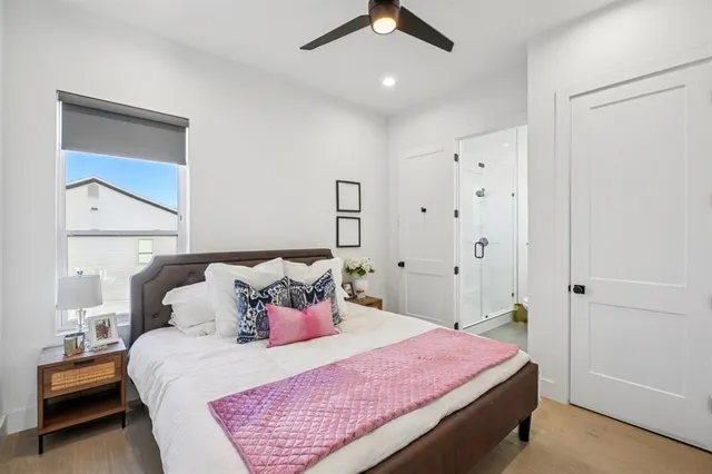 a bedroom with a bed and a night stand