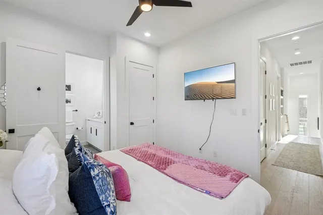 a bedroom with a bed and a flat screen tv