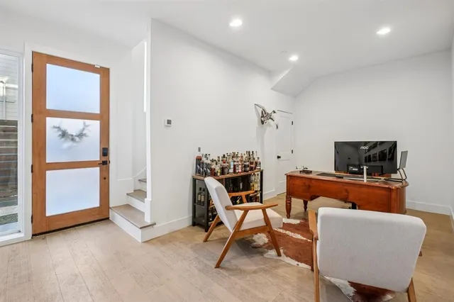 a view of a livingroom with furniture and a flat screen tv
