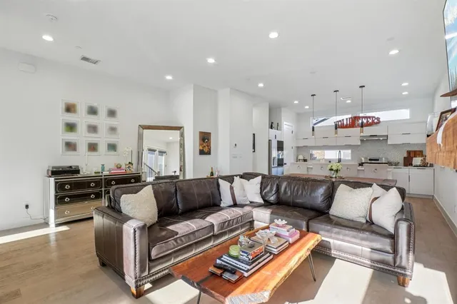 a living room with furniture and kitchen view