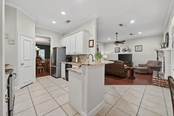 a kitchen with refrigerator and cabinets