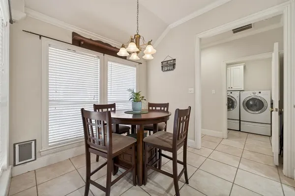 a view of a dining room with furniture and chandelier