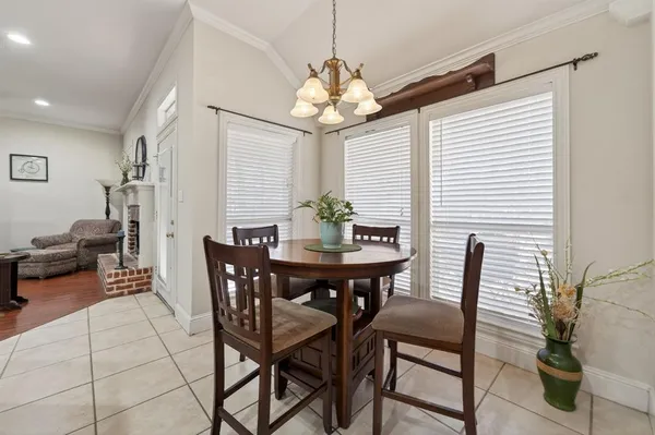 a view of a dining room with furniture and chandelier