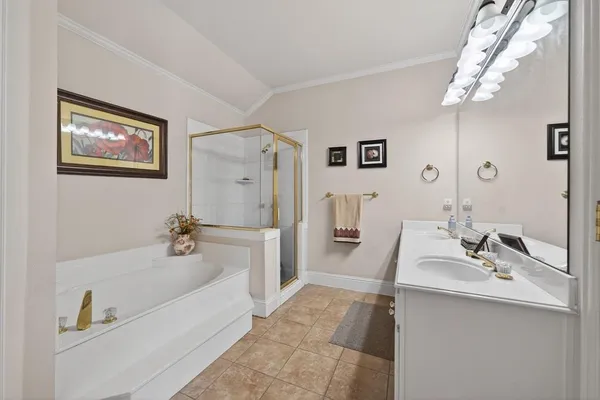 a bathroom with a tub sink and mirror