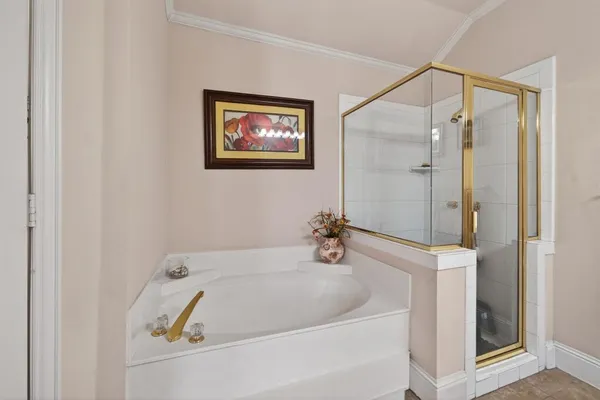 a bathroom with a tub and shower