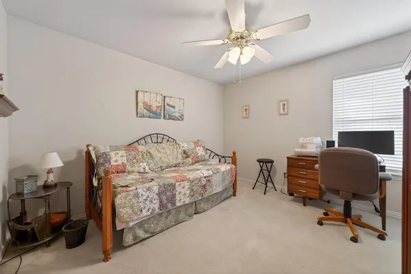 a bedroom with a bed and a chair