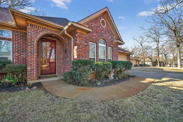 a view of a brick building next to a yard