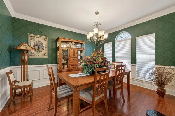 a view of a dining room with furniture wooden floor and chandelier