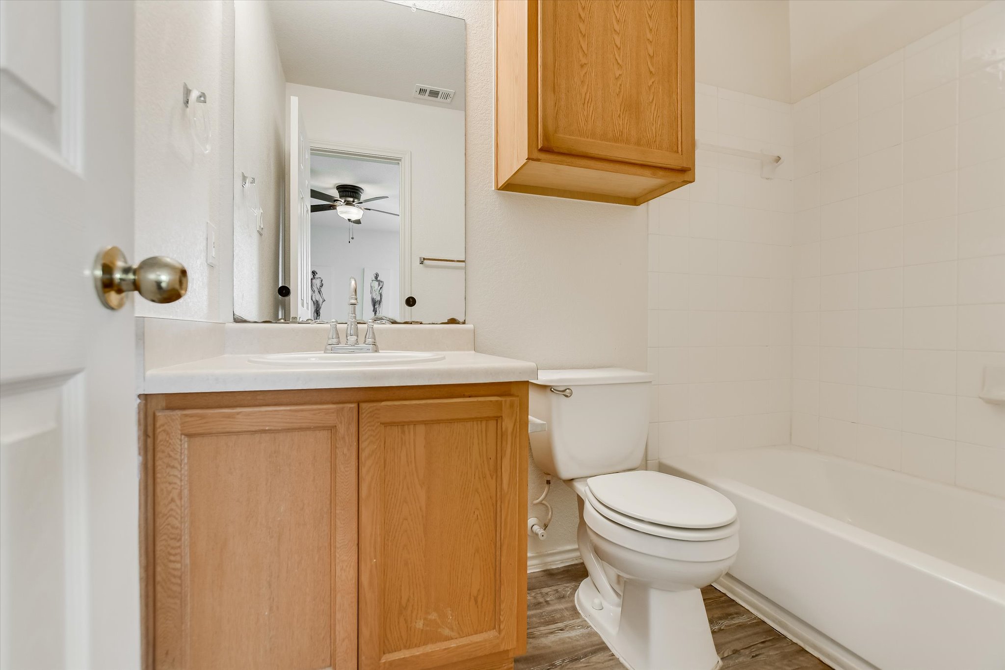 809 Sebastian Bend, Unit B Pflugerville, TX 78660 - Photo 17 of 34 Full bathroom with vanity, wood finished floors, shower / tub combination, and a ceiling fan