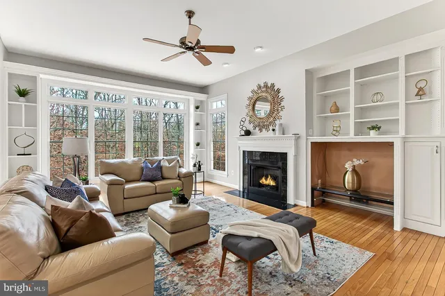 a kitchen with stainless steel appliances granite countertop a stove top oven a dining table and chairs with wooden floor