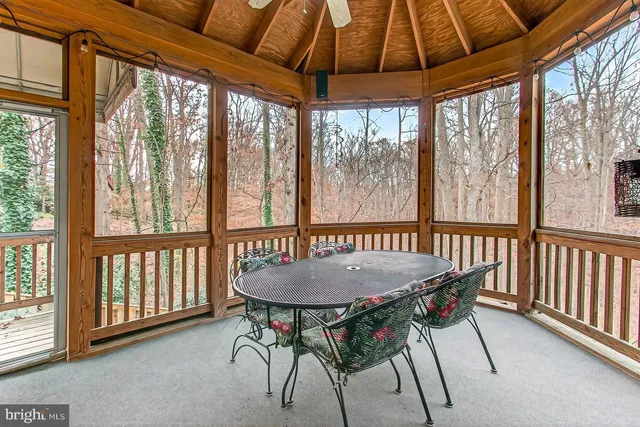 a dining room with furniture window and wooden floor