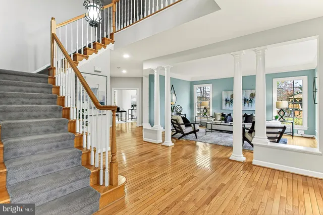 a view of entryway and hall with wooden floor