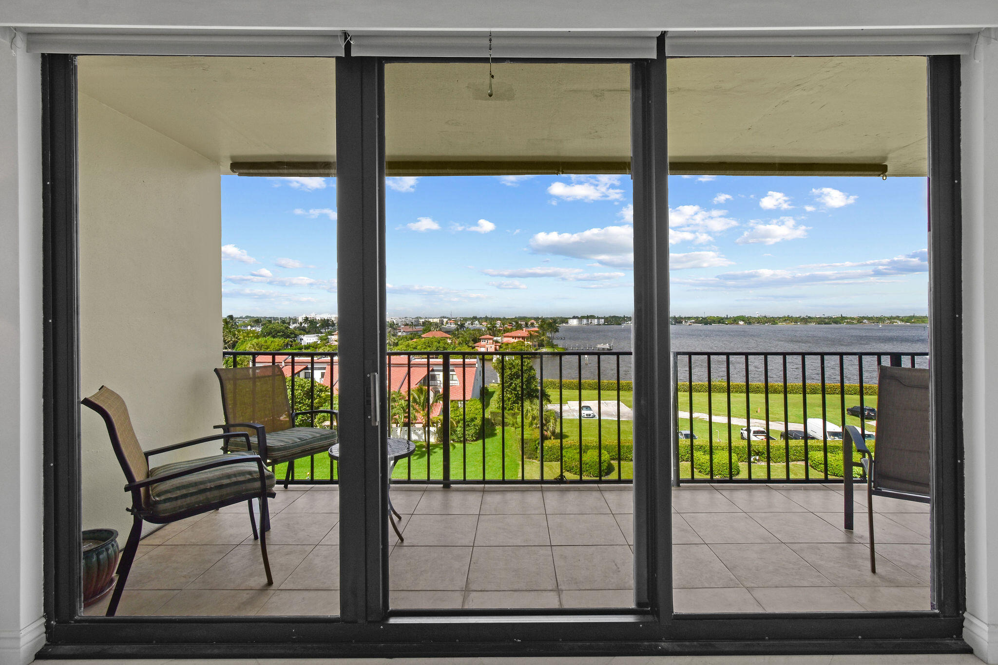 3460 South Ocean Boulevard, Unit 5100 Palm Beach, FL 33480 - Photo 19 of 42 a view of a glass door with a bench from a window
