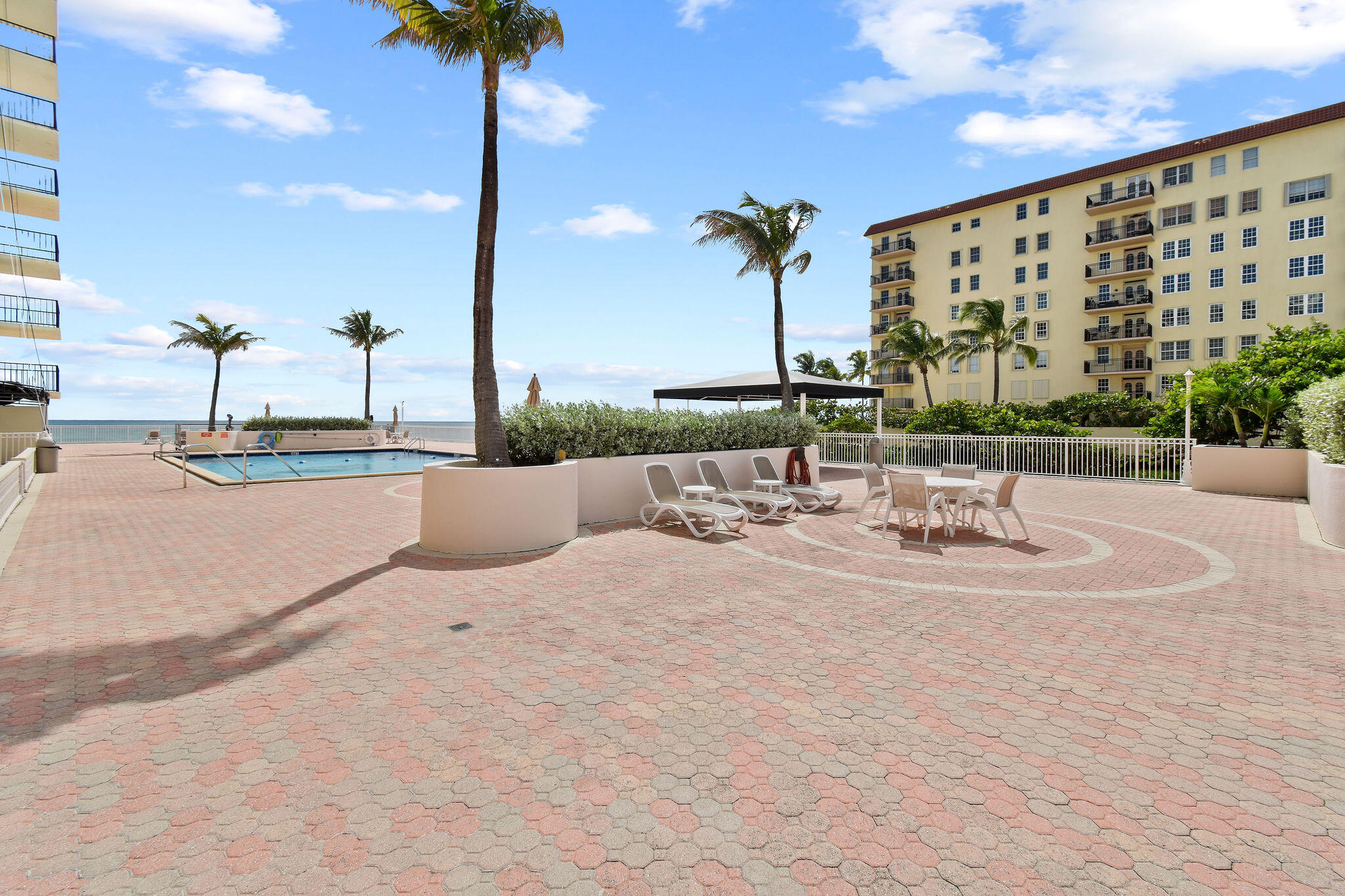 3460 South Ocean Boulevard, Unit 5100 Palm Beach, FL 33480 - Photo 30 of 42 a terrace with a table and chairs