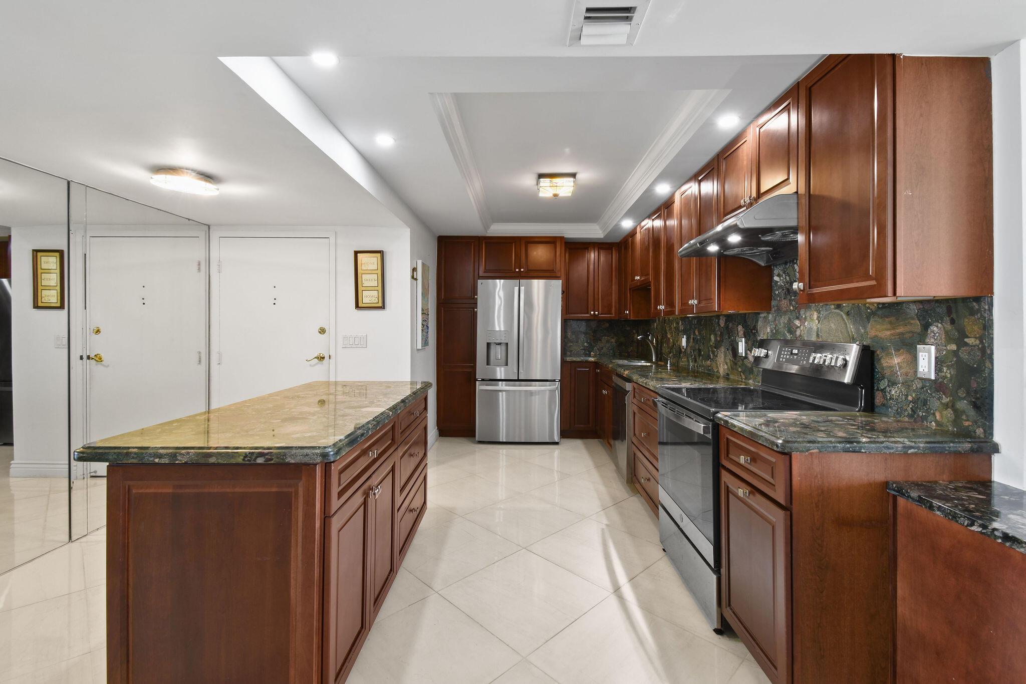 3460 South Ocean Boulevard, Unit 5100 Palm Beach, FL 33480 - Photo 6 of 42 a kitchen with stainless steel appliances granite countertop a sink stove and refrigerator