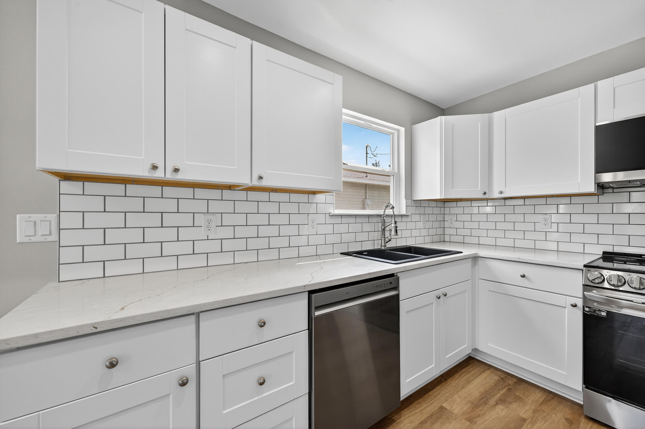 5327 B Kervin Road Crestview, FL 32539 - Photo 14 of 47 a kitchen with white cabinets appliances a sink and a counter top