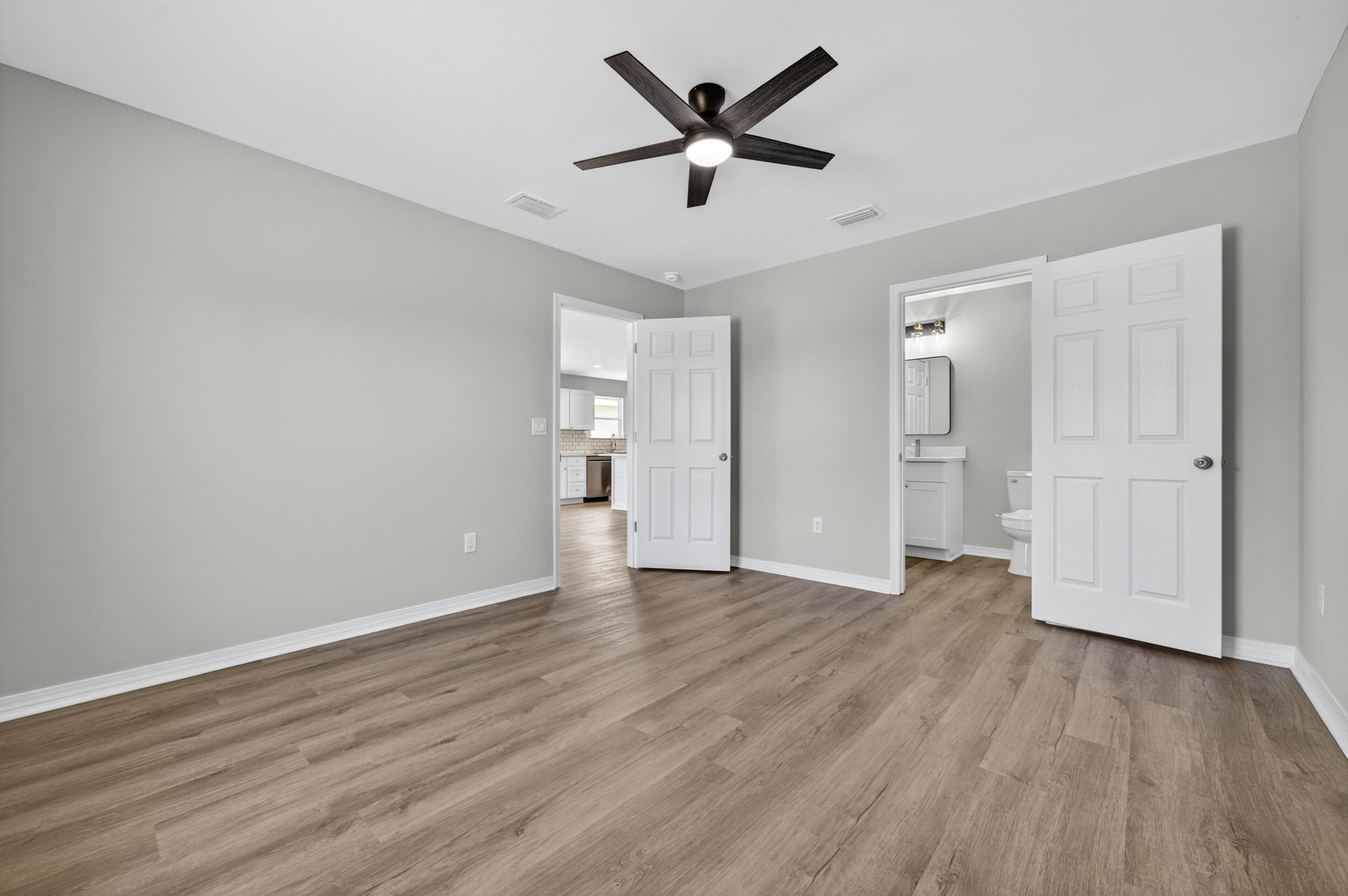 5327 B Kervin Road Crestview, FL 32539 - Photo 24 of 47 an empty room with wooden floor and ceiling fan