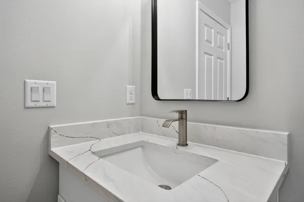a bathroom with a sink and a mirror