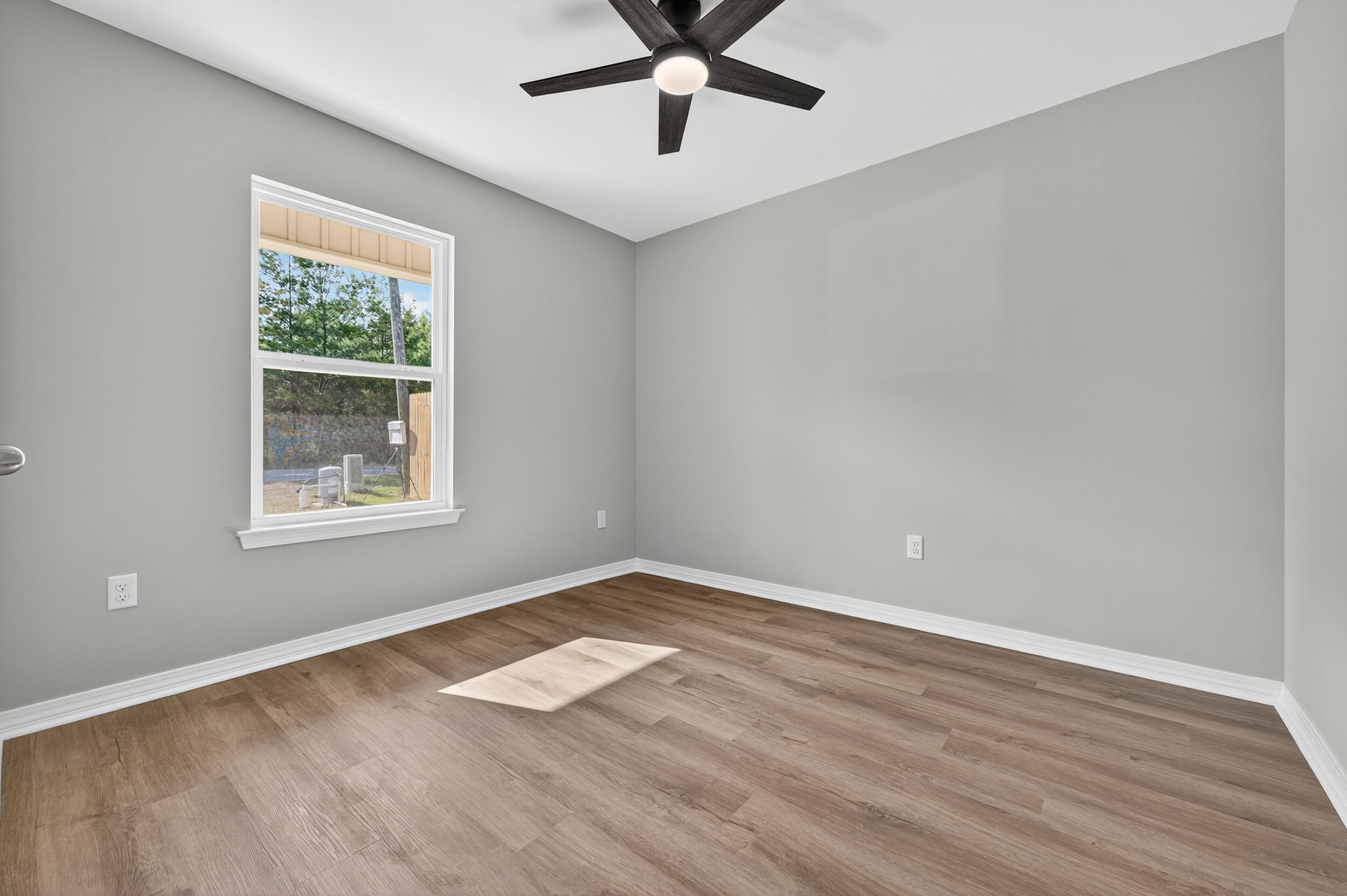 5327 B Kervin Road Crestview, FL 32539 - Photo 30 of 47 a view of an empty room with wooden floor and a window