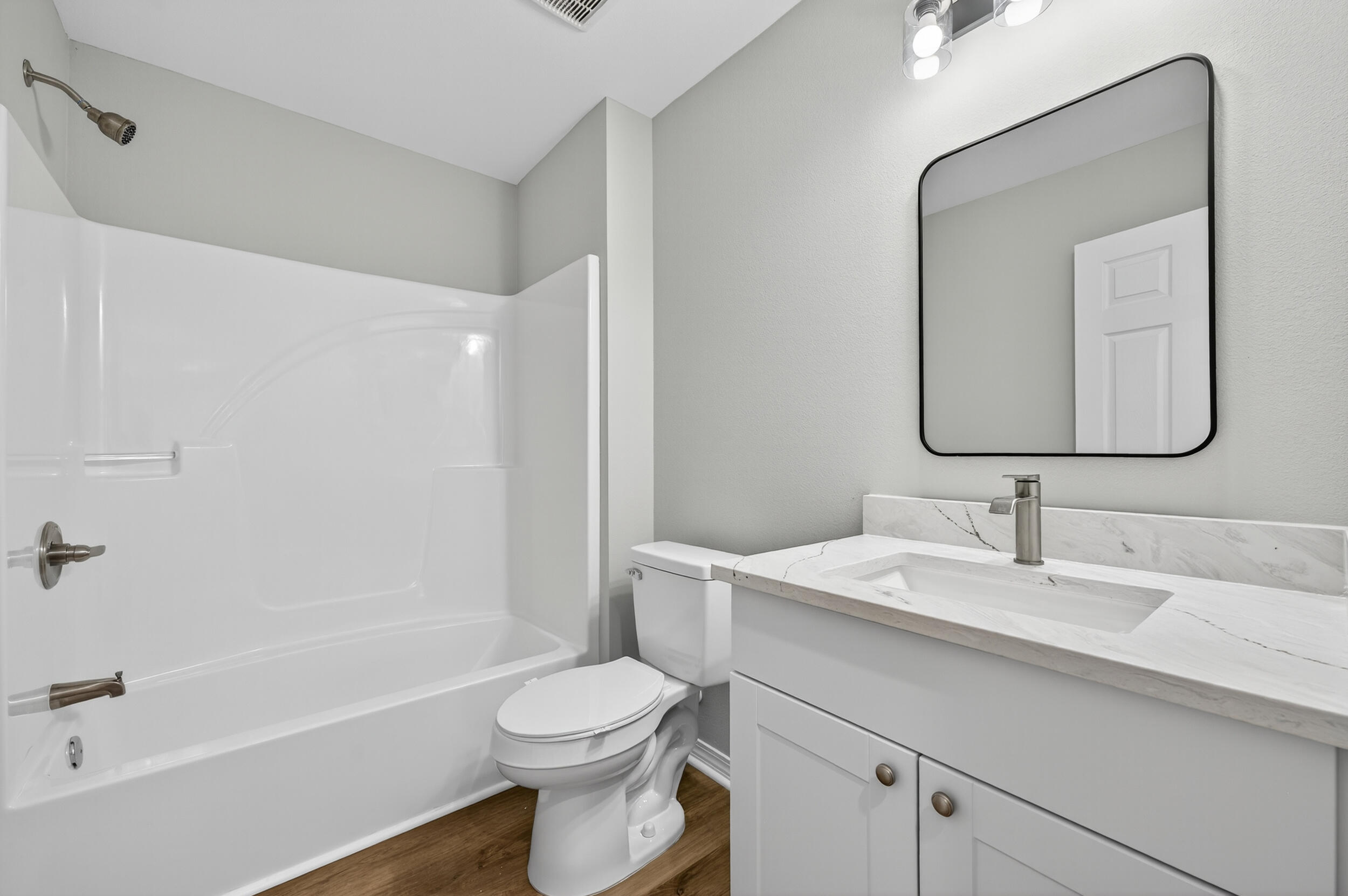 5327 B Kervin Road Crestview, FL 32539 - Photo 32 of 47 a bathroom with a toilet a sink a bathtub and a mirror