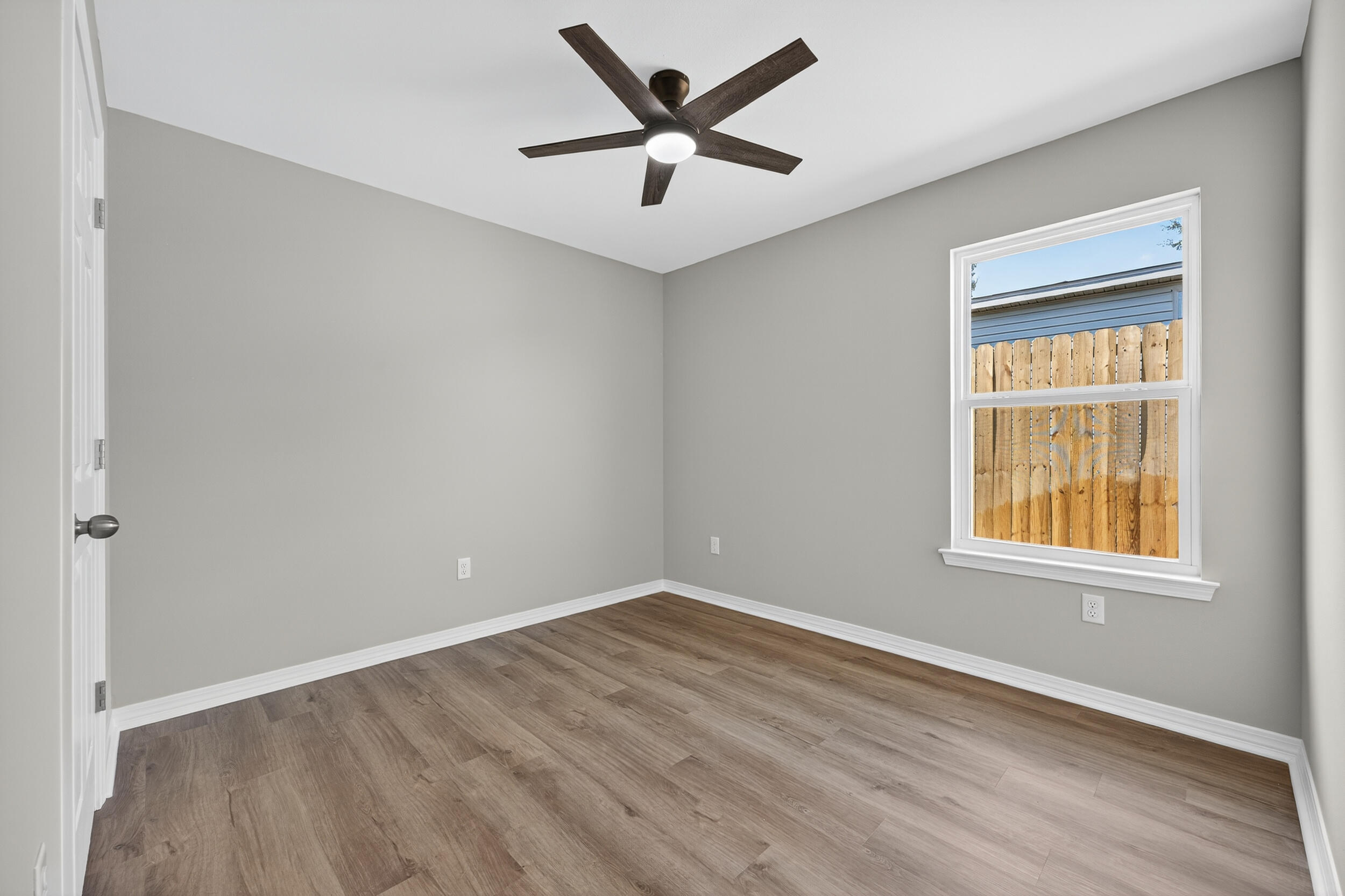 5327 B Kervin Road Crestview, FL 32539 - Photo 35 of 47 an empty room with a window and a ceiling fan