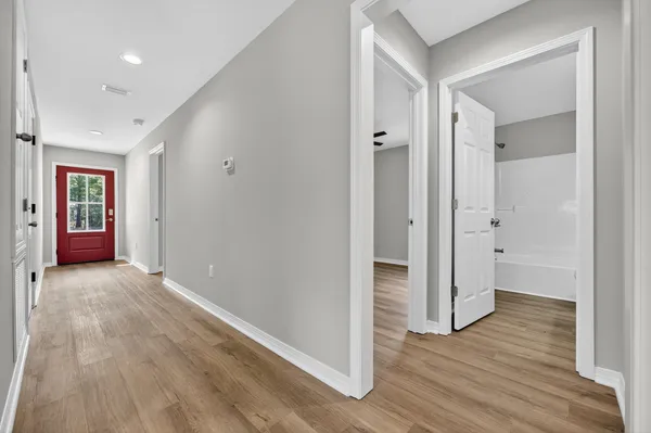 a kitchen with a sink cabinets and wooden floor