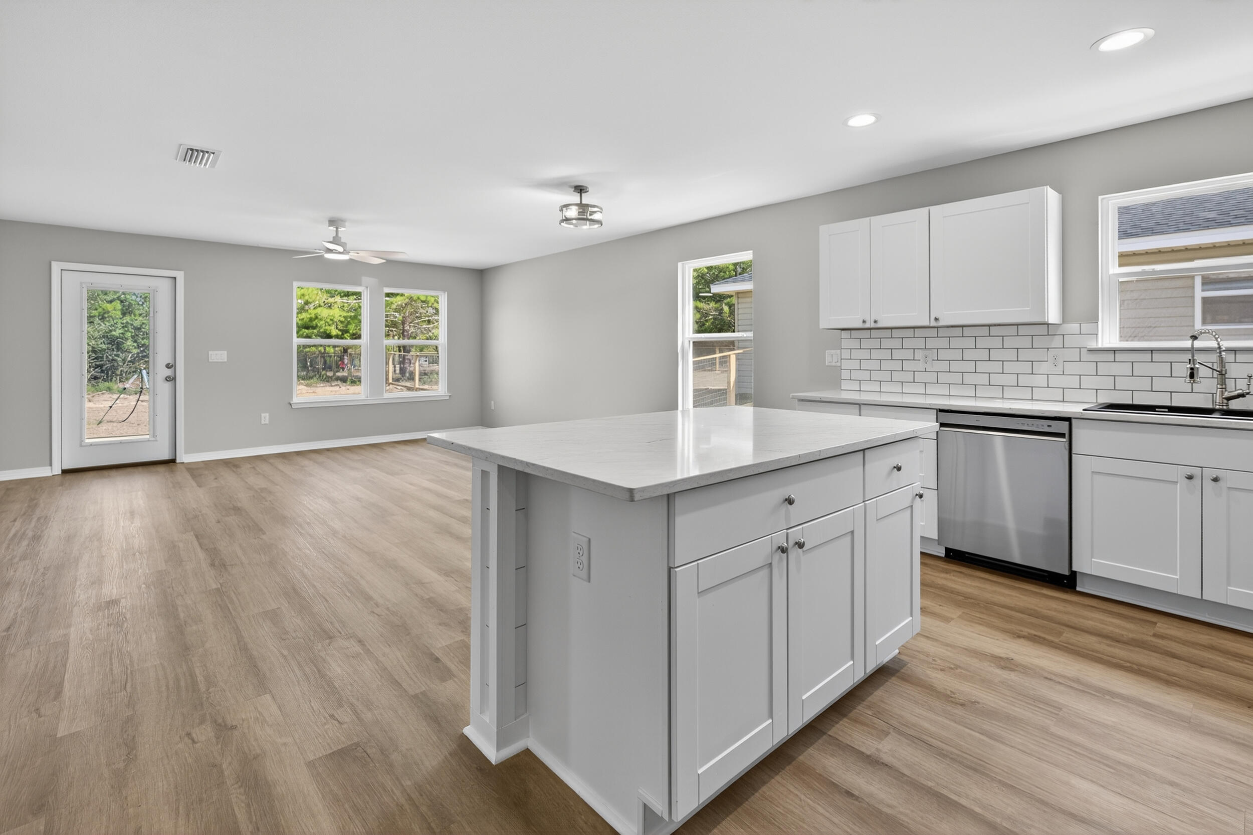 5327 B Kervin Road Crestview, FL 32539 - Photo 9 of 47 a kitchen with a sink cabinets and wooden floor