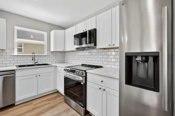 a kitchen with appliances cabinets and a sink
